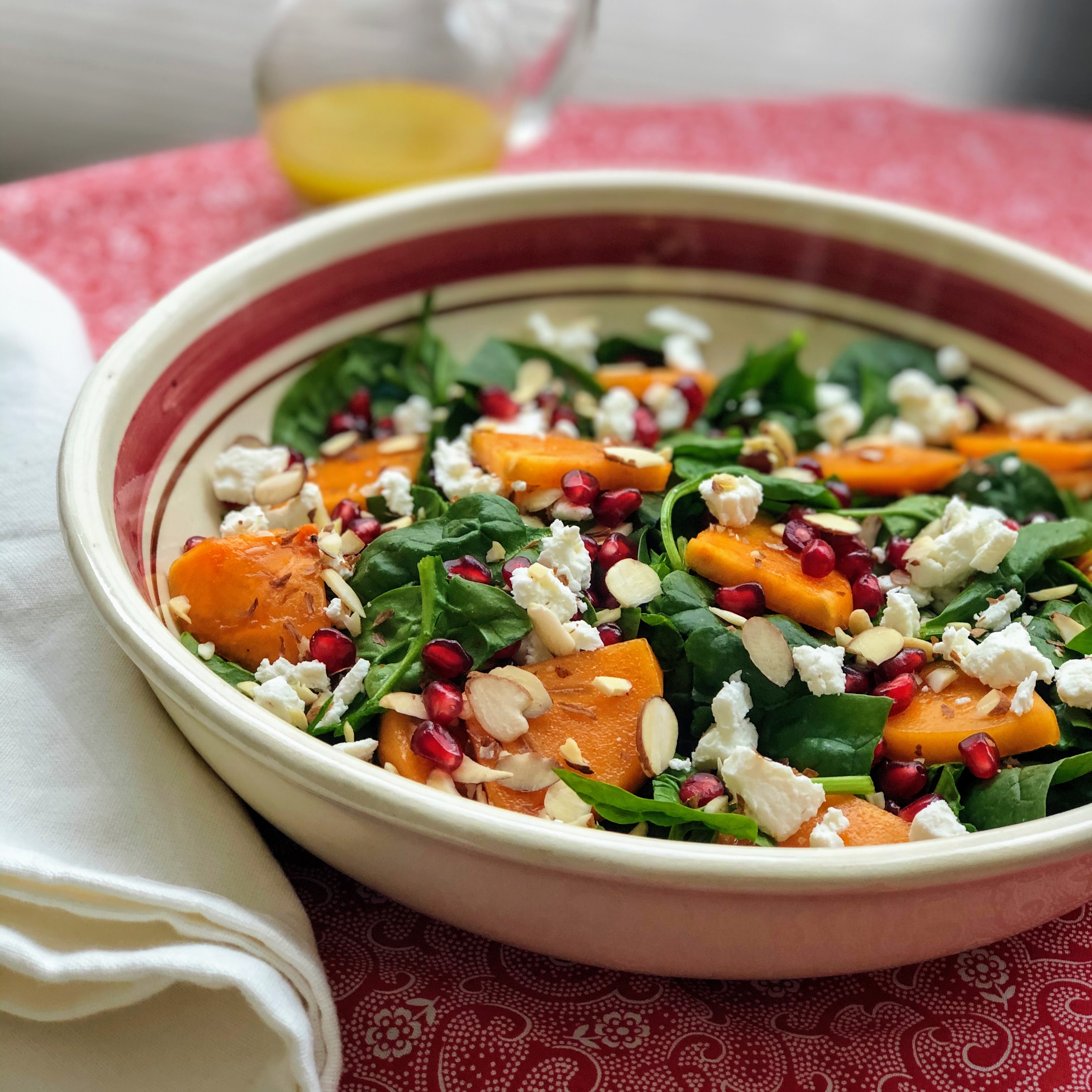 Spinach and Persimmon Salad with Goat Cheese and Pomegranate